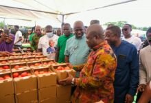 Mr Opoku (front row second from right) with Mr James Gunu (right) and other participants inspecting the tomotoes on display during the launch