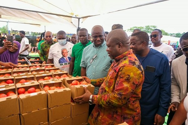 Mr Opoku (front row second from right) with Mr James Gunu (right) and other participants inspecting the tomotoes on display during the launch