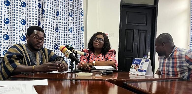 Mr Atasige, (in smock) addressing the news conference