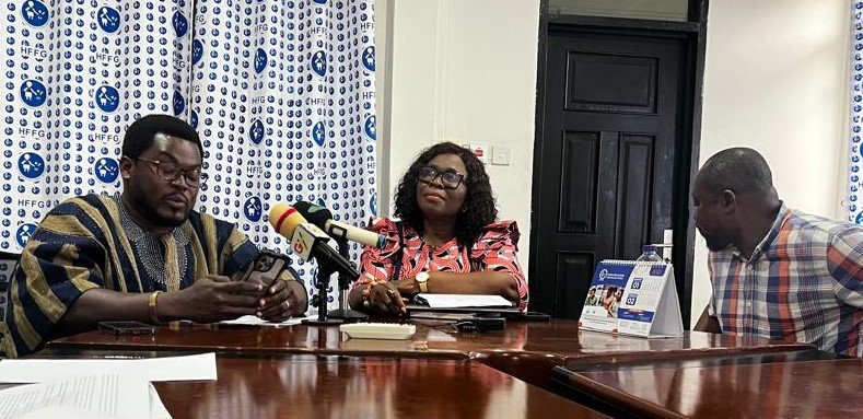 Mr Atasige, (in smock) addressing the news conference