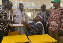 Mr Issah (third from left) presenting the furniture to Chief Salifu
