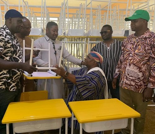 Mr Issah (third from left) presenting the furniture to Chief Salifu