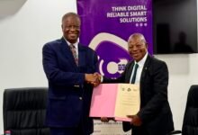 Professor Malcalm (right) and Dr Kludjeson displaying the signed MOU
