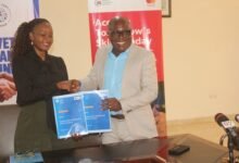 Mr Eric K. Adzroe (right) and Ms Constance Swaniker exchanging the signed document. Photo. Ebo Gorman