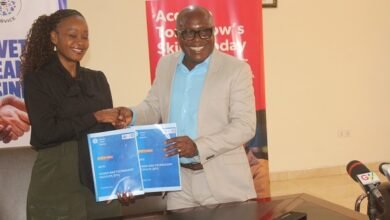 Mr Eric K. Adzroe (right) and Ms Constance Swaniker exchanging the signed document. Photo. Ebo Gorman