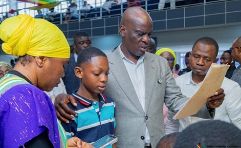 Mr Haruna Iddrisu, holding the results slip of one of the graduates at the CSSPS Resolution Centre at GNAT Hall in Accra