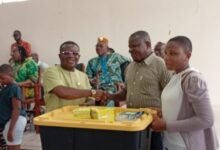 Mr Kpotosu presenting the items to a beneficiary at the ceremony