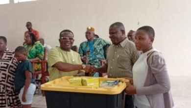 Mr Kpotosu presenting the items to a beneficiary at the ceremony