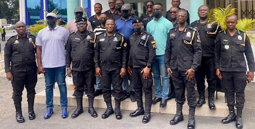 Mr Christian TettehYohuno (middle) with some members of the police management baord and the promoted officers
