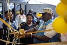 Mr Allotey-Gaisie (right) being assisted by other officials to cut the tape to inaugurate the facility