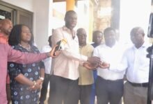 Mr Anyetei (second from left) presenting the keys to the vehicles to Officers from the departments. With them is Ms Rita Sowah Photo Victor A. Buxton