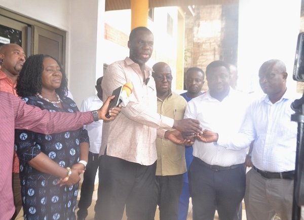 Mr Anyetei (second from left) presenting the keys to the vehicles to Officers from the departments. With them is Ms Rita Sowah Photo Victor A. Buxton