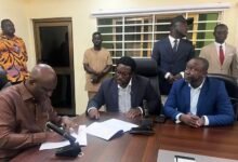 Mr Opoku (left) with Mr Adimado and others during the signing ceremony