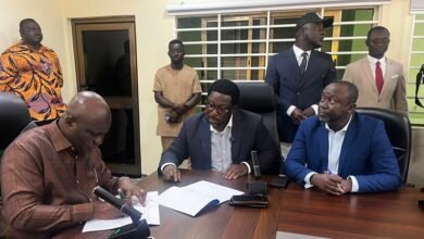 Mr Opoku (left) with Mr Adimado and others during the signing ceremony