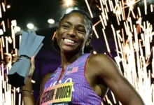 Melissa Jefferson-Wooden celebrates with the trophy after winning the 200m final