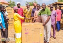 Alhaji Mahama (right) presenting the items to Nma Asana one of the beneficiaries