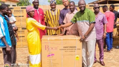 Alhaji Mahama (right) presenting the items to Nma Asana one of the beneficiaries