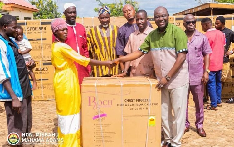 Alhaji Mahama (right) presenting the items to Nma Asana one of the beneficiaries