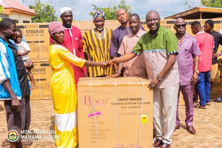 Alhaji Mahama (right) presenting the items to Nma Asana one of the beneficiaries