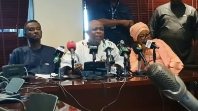 Mr Agalga (middle) speaking at the press briefing
