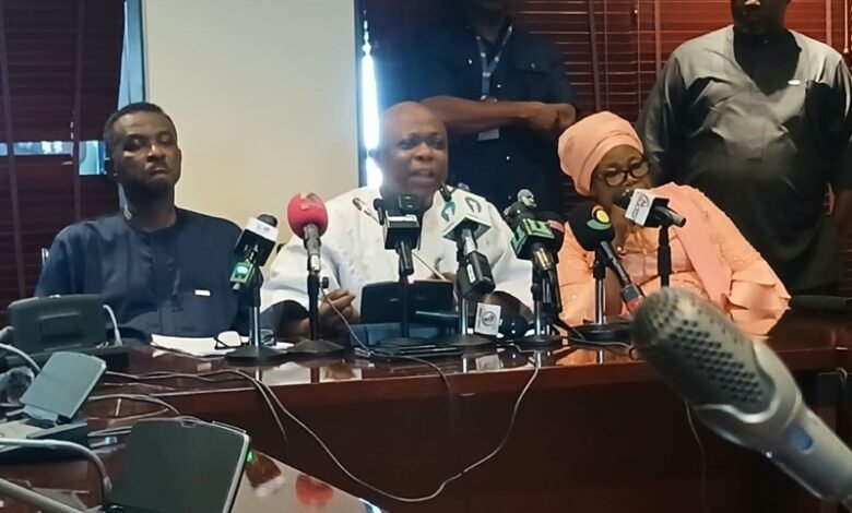 Mr Agalga (middle) speaking at the press briefing