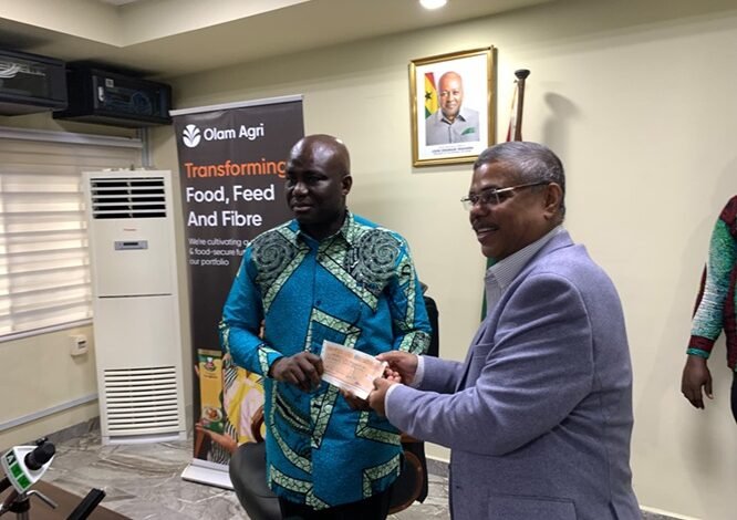 Mr Opoku (left) receiving the cheque from Mr Biswas at the ceremony