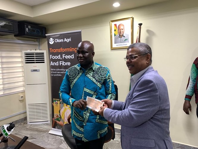 Mr Opoku (left) receiving the cheque from Mr Biswas at the ceremony