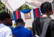 People line up to sign a condolence book in honour of late Haitian President Jovenel Moise in Cap-Haitien