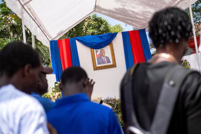 People line up to sign a condolence book in honour of late Haitian President Jovenel Moise in Cap-Haitien
