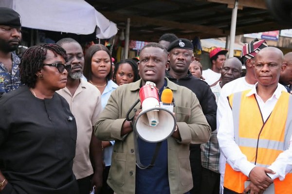 Mr George (middle) and other dignitaries during an inspection tour to the mast installation site