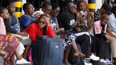 Stranded travellers wait with their luggage after flight operations were disrupted due to the strike