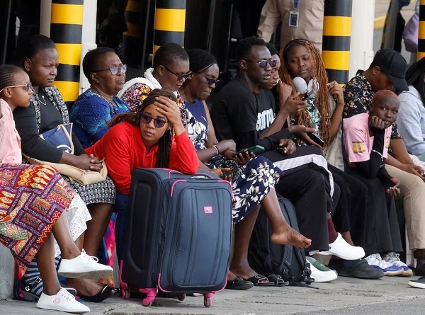 Stranded travellers wait with their luggage after flight operations were disrupted due to the strike
