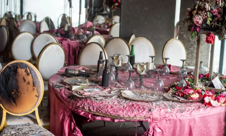 Tablescapes are covered in ash and debris in the aftermath of a fire that broke out in a building hosting a wedding party in Lingwala