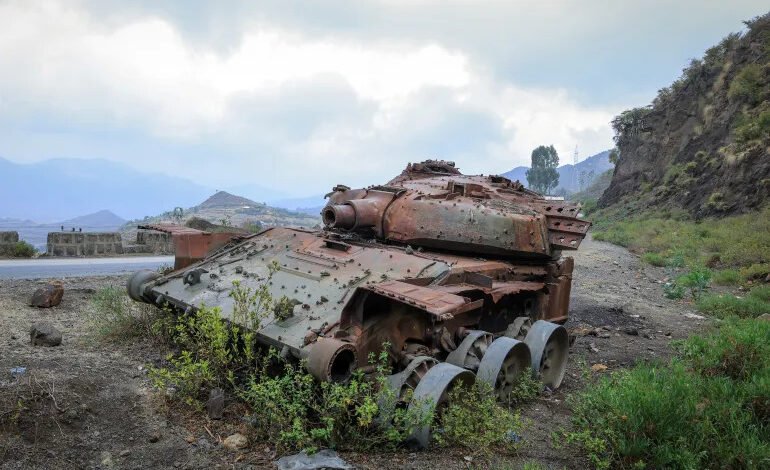 The charred remains of a tank from fighting between the Ethiopian military and the Tigray People’s Liberation Front sit on a road near Gereb Agew in southern Tigray