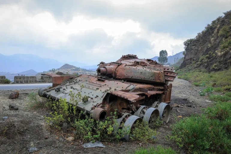The charred remains of a tank from fighting between the Ethiopian military and the Tigray People’s Liberation Front sit on a road near Gereb Agew in southern Tigray 