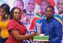 Ms Bright Antwiwaa, a staff of Newmont Ahafo Development Foundation, presenting the best mining award to Mr Daniel Dzirasah