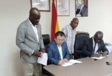 Mr Iddrisu (standing left) withnessing the signining of the MOU