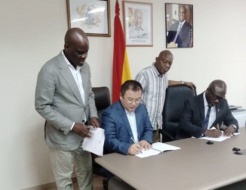 Mr Iddrisu (standing left) withnessing the signining of the MOU