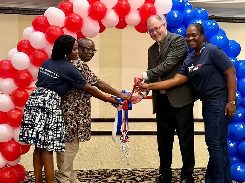 US Embassy hosts k----Mr Oslon (second from right) with other dignitaries cutting the tape to open the fair