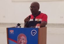 Mr Woanya (inset) speaking at the programme