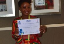 Christine Dzakah displaying her AIPS Young Reporter’s Program Certificate of Achievement