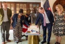 Mr Haruna Iddrisu (third from right) with Rolf Olson (second from right) and other dignitaries cutting the anniversary cake