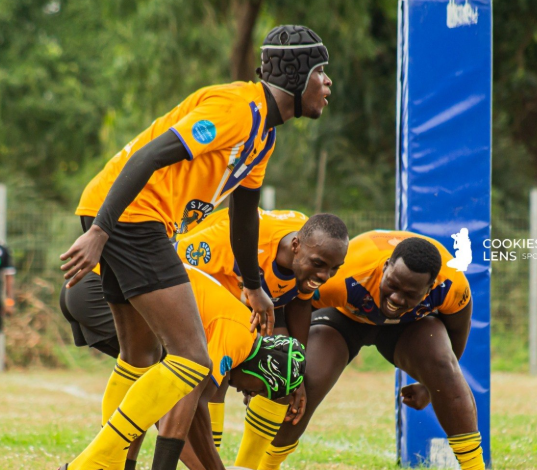 Titans' Papa Sakyi Baidoo (with ball) scores a Try whiles being flanked by teammates