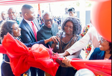 Vice President Professor Naana Jane Opoku-Agyemang being assisted to cut the tape to open Absa Bank Ghana's new head office in Accra