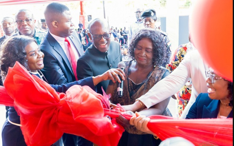 Vice President Professor Naana Jane Opoku-Agyemang being assisted to cut the tape to open Absa Bank Ghana's new head office in Accra