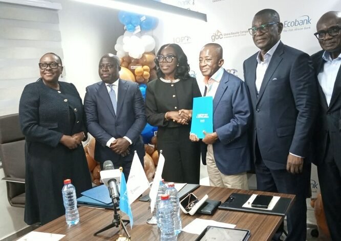 Mr Ofori-Poku (third from right) exchanging the signed document with Mrs Osei-Poku, while officials of the two organisations look on