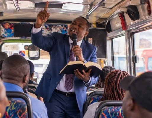 A pastor preaching on a bus