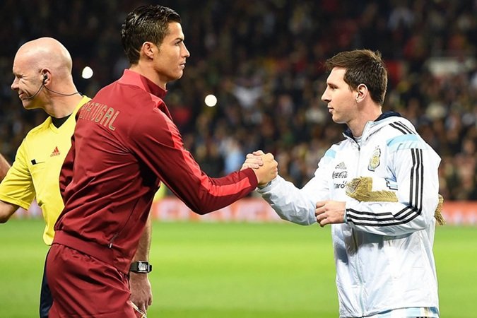 Cristiano Ronaldo and Leo Messi shake hands ahead of an international friendly