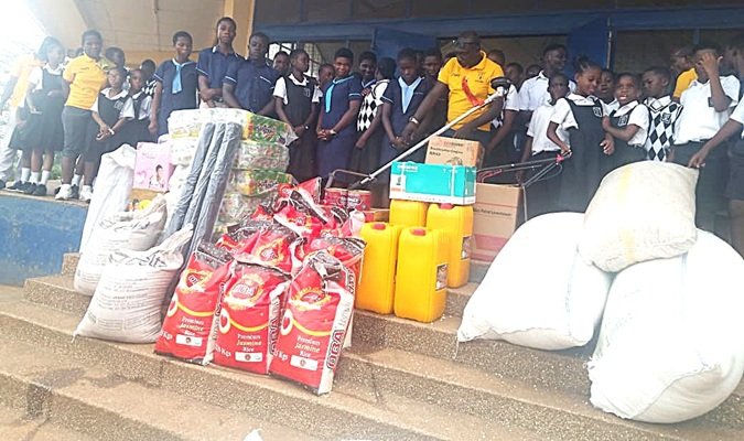 Both students from De Youngsters International School and Akropong School for the Blind with items after the donation