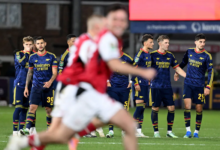 Dejected Arsenal players look on as Fleetwood players celebrate